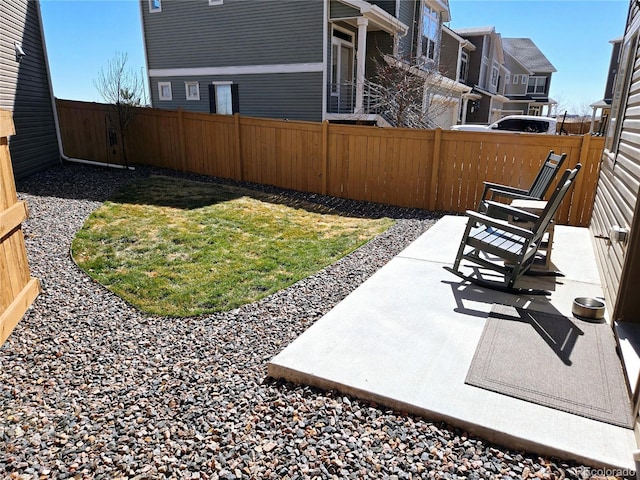 view of yard with a residential view, a patio area, and a fenced backyard