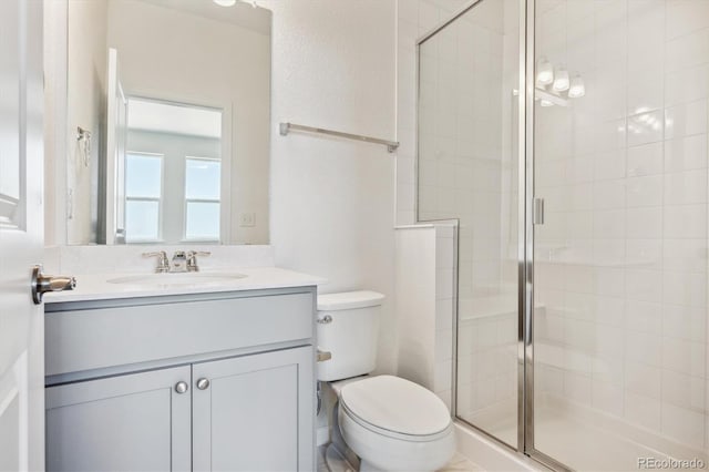 bathroom with vanity, toilet, and walk in shower