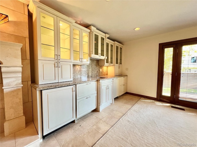 interior space with visible vents, light tile patterned flooring, recessed lighting, a sink, and backsplash