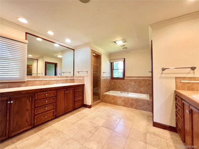 bathroom featuring vanity, crown molding, a garden tub, tile patterned floors, and a stall shower