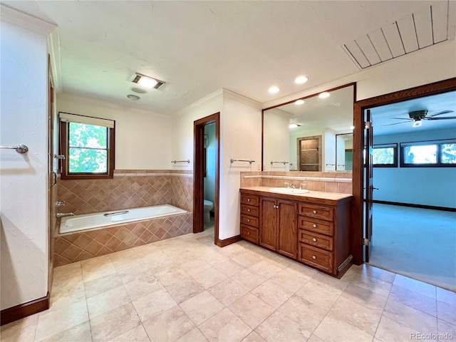 bathroom featuring plenty of natural light, ornamental molding, a bath, and toilet