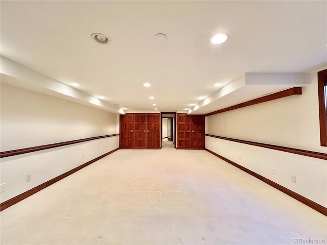 unfurnished room with baseboards, light carpet, and recessed lighting