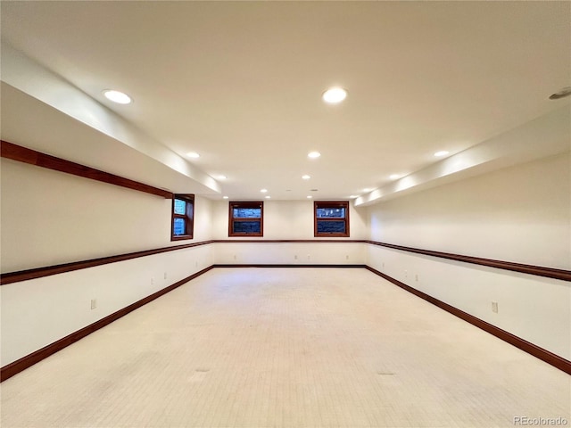basement with recessed lighting, baseboards, and light colored carpet
