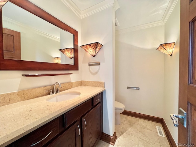 bathroom with vanity, crown molding, visible vents, toilet, and baseboards