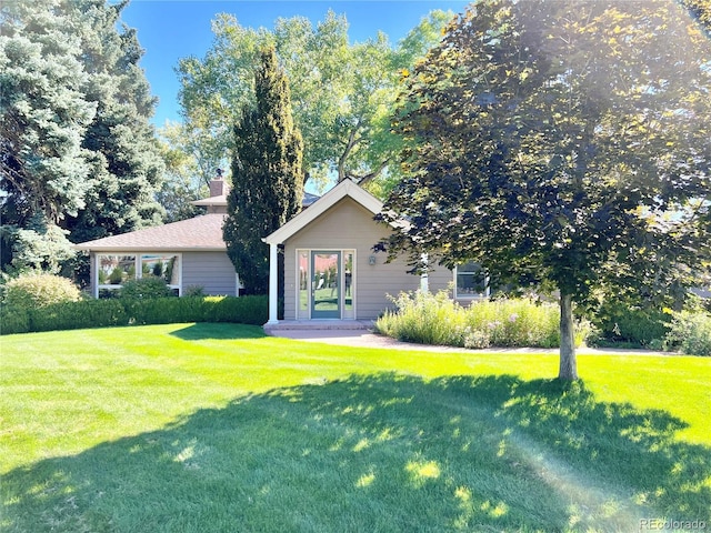 view of front of house with a chimney and a front yard