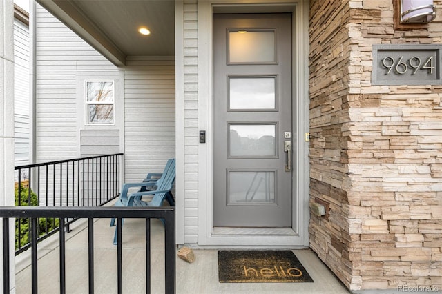 doorway to property with stone siding