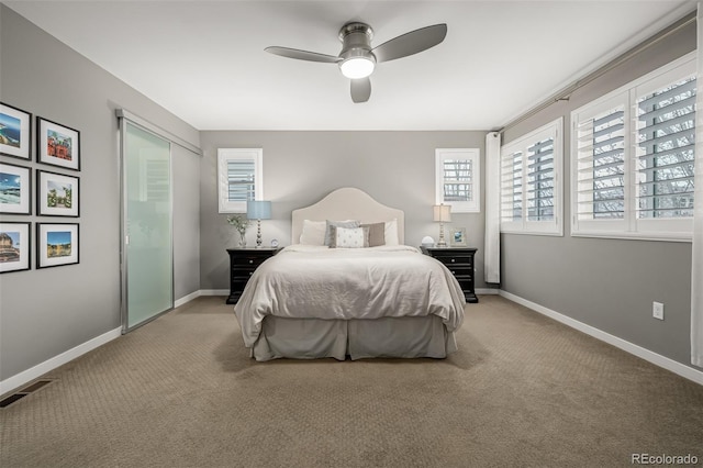 bedroom featuring ceiling fan, light colored carpet, visible vents, and baseboards
