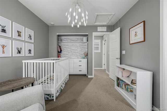 bedroom with visible vents, baseboards, carpet, attic access, and a closet