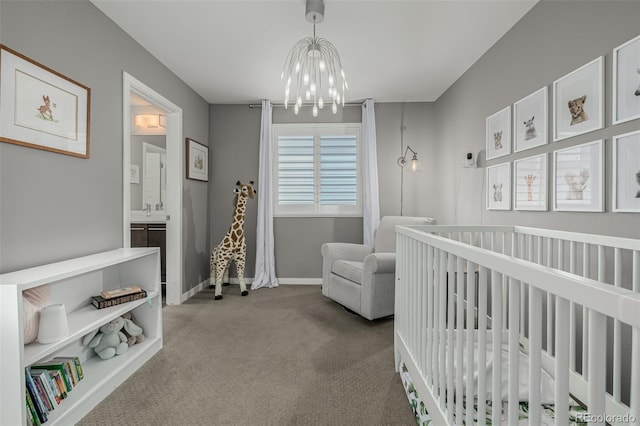 bedroom with a chandelier, carpet flooring, a crib, and baseboards