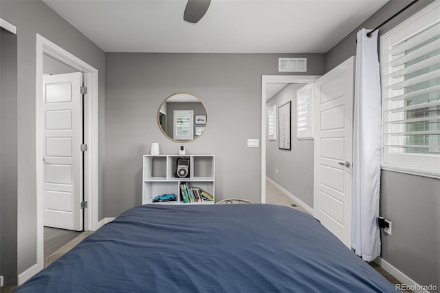 bedroom with visible vents, ceiling fan, and baseboards