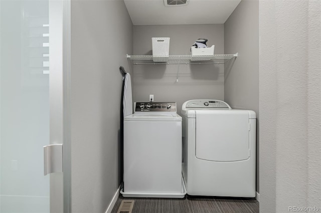 laundry area featuring laundry area, baseboards, and washer and clothes dryer