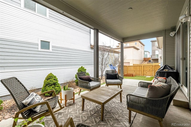 view of patio featuring outdoor lounge area and fence