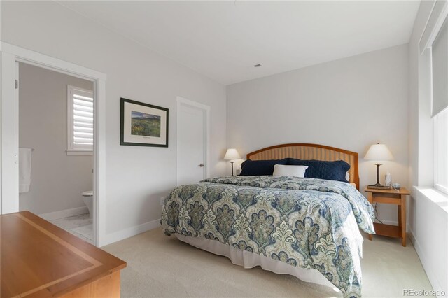 bedroom featuring light carpet and baseboards