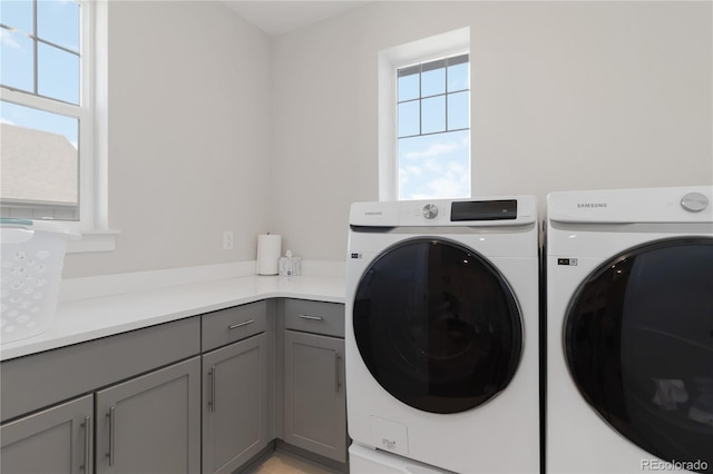 laundry area with cabinet space and washer and dryer