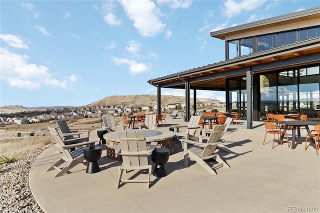 view of patio featuring outdoor dining area and a mountain view
