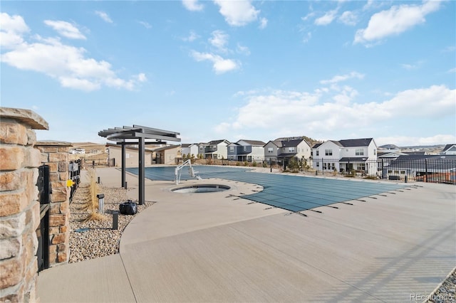 view of swimming pool featuring fence, a residential view, a pergola, a patio area, and a hot tub