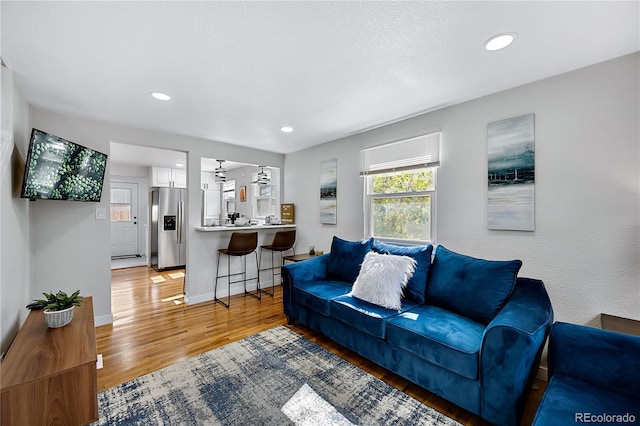 5570 Otis Ct, Arvada, CO 80002 - living room with light wood finished floors, recessed lighting, and baseboards