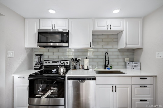 5570 Otis Ct, Arvada, CO 80002 - kitchen with stainless steel appliances, a sink, decorative backsplash, and light countertops