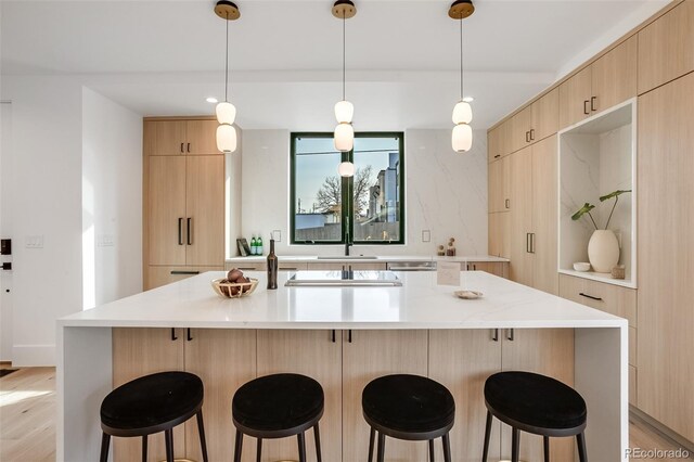 1459 W 42nd Ave, Denver, CO 80211 - kitchen featuring light brown cabinetry, modern cabinets, and a kitchen bar