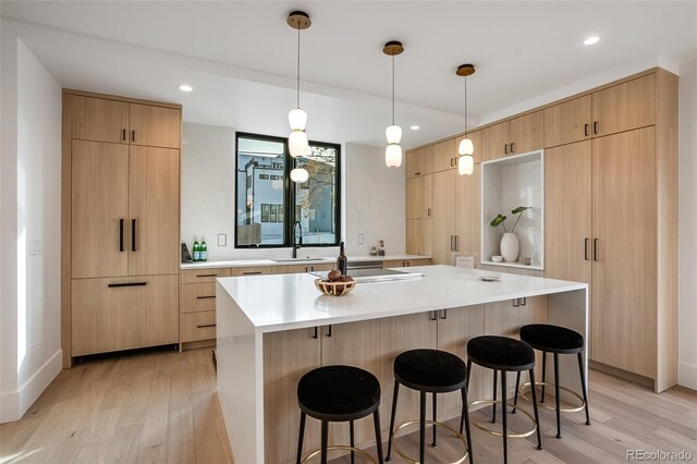 1459 W 42nd Ave, Denver, CO 80211 - kitchen with a sink, a kitchen bar, and light wood-style flooring