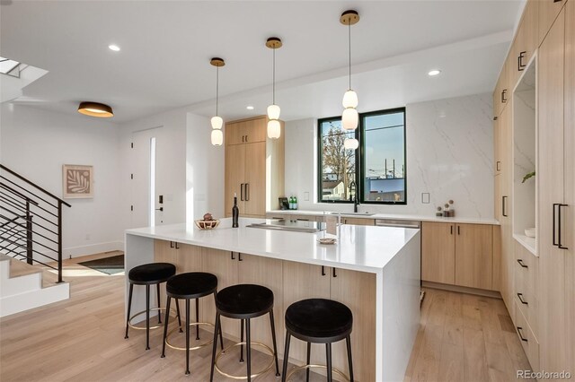 1459 W 42nd Ave, Denver, CO 80211 - kitchen featuring light wood-type flooring, modern cabinets, light brown cabinetry, and a breakfast bar