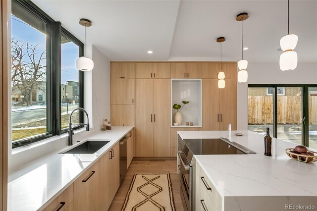 1459 W 42nd Ave, Denver, CO 80211 - kitchen with light brown cabinetry, stainless steel appliances, a sink, and light wood-style floors