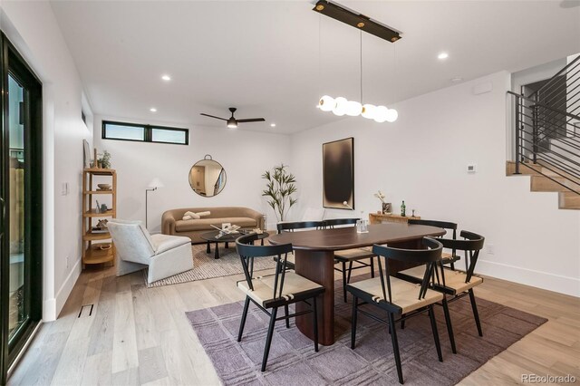 1459 W 42nd Ave, Denver, CO 80211 - dining area with stairway, baseboards, ceiling fan, and light wood-style flooring