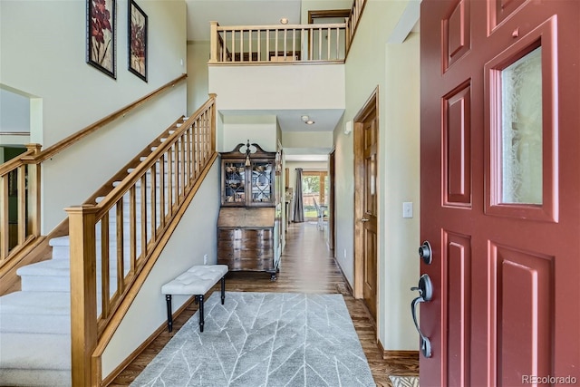 4498 Buena Vista Ct, Castle Rock, CO 80109 - foyer featuring wood finished floors, stairway, a towering ceiling, and baseboards