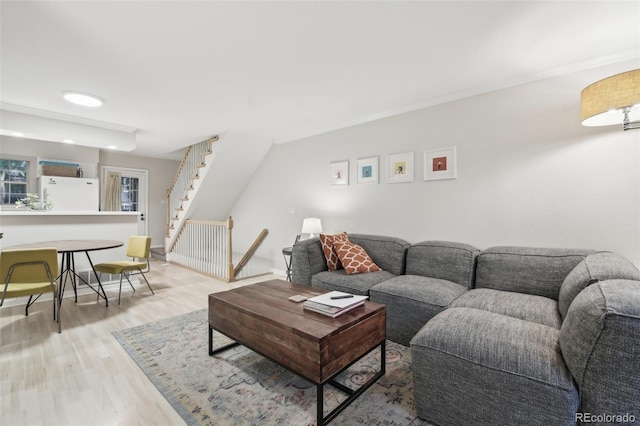 1198 Milo Cir Unit A, Lafayette, CO 80026 - living room featuring light wood-type flooring, stairs, and baseboards