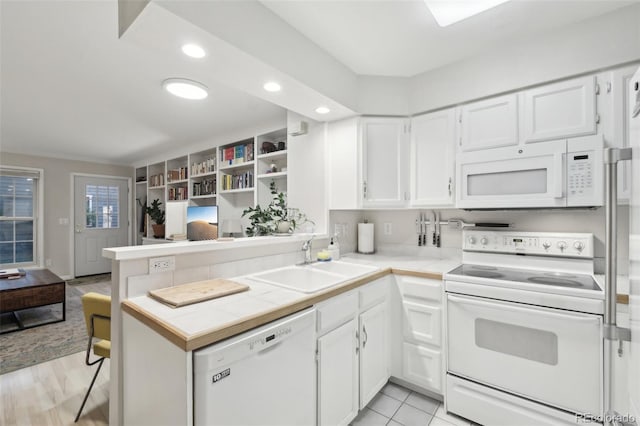 1198 Milo Cir Unit A, Lafayette, CO 80026 - kitchen with white appliances, a sink, white cabinetry, tile counters, and recessed lighting