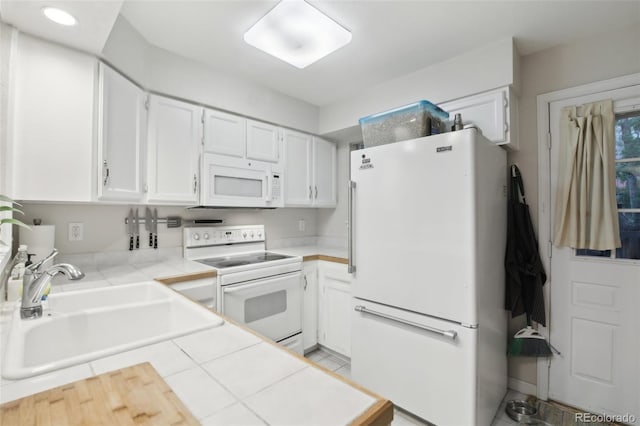 1198 Milo Cir Unit A, Lafayette, CO 80026 - kitchen with white appliances, a sink, white cabinets, tile counters, and recessed lighting