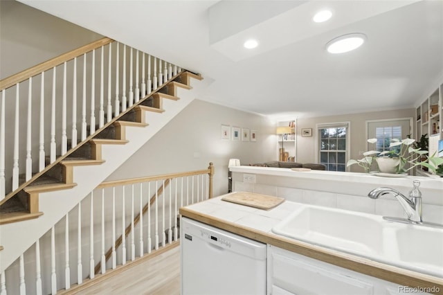 1198 Milo Cir Unit A, Lafayette, CO 80026 - kitchen featuring white dishwasher, a sink, open floor plan, tile counters, and recessed lighting