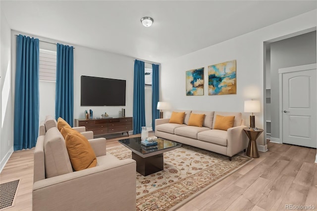 21204 E 63rd Dr, Aurora, CO 80019 - living area featuring light wood-style flooring, visible vents, and baseboards