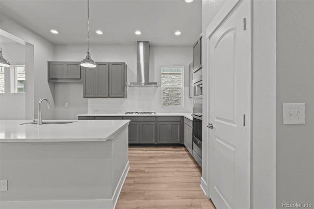 21204 E 63rd Dr, Aurora, CO 80019 - kitchen with wall chimney range hood, gray cabinets, a healthy amount of sunlight, and a sink