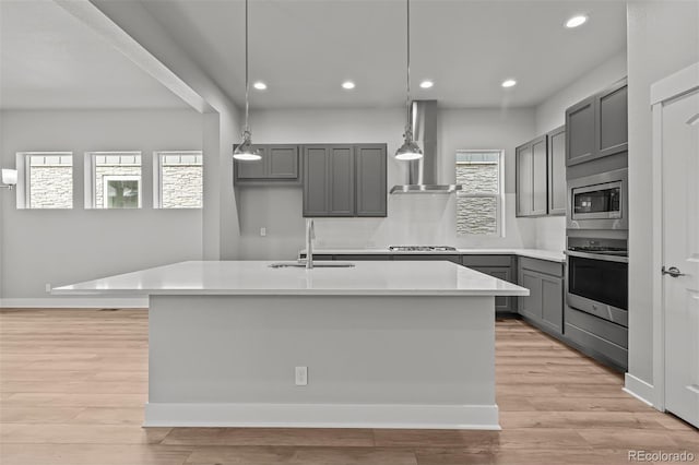 21204 E 63rd Dr, Aurora, CO 80019 - kitchen featuring wall chimney exhaust hood, stainless steel appliances, a sink, recessed lighting, and gray cabinetry
