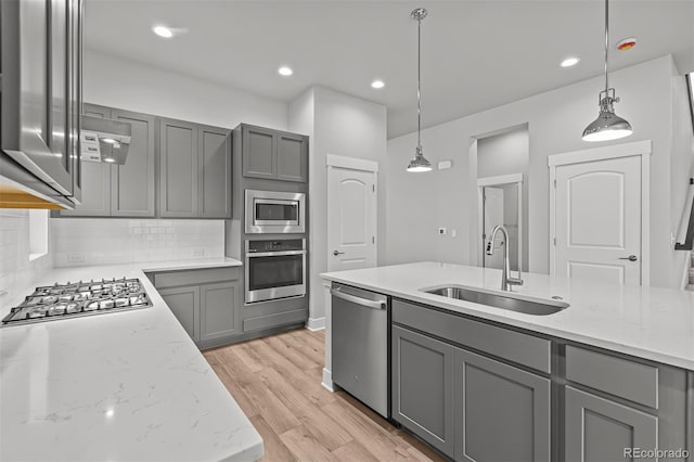 21204 E 63rd Dr, Aurora, CO 80019 - kitchen with light wood-style floors, gray cabinetry, stainless steel appliances, and a sink