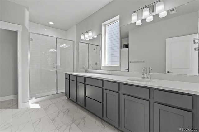 21204 E 63rd Dr, Aurora, CO 80019 - bathroom with a shower stall, marble finish floor, a sink, and double vanity