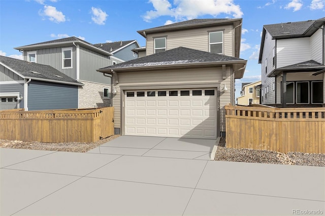 21204 E 63rd Dr, Aurora, CO 80019 - traditional-style home with concrete driveway, an attached garage, fence, and a shingled roof