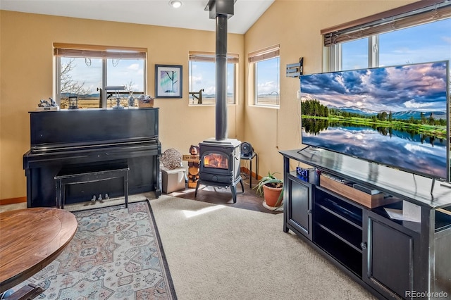 612 Sheep Ridge Rd, Fairplay, CO 80440 - sitting room featuring a wood stove, plenty of natural light, carpet flooring, and vaulted ceiling