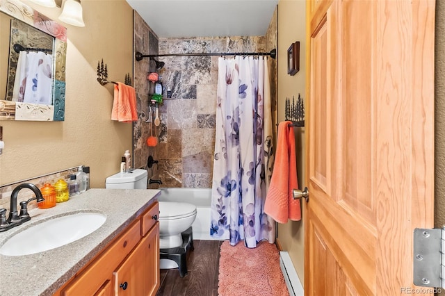 612 Sheep Ridge Rd, Fairplay, CO 80440 - bathroom with baseboard heating, shower / bath combination with curtain, vanity, and wood finished floors