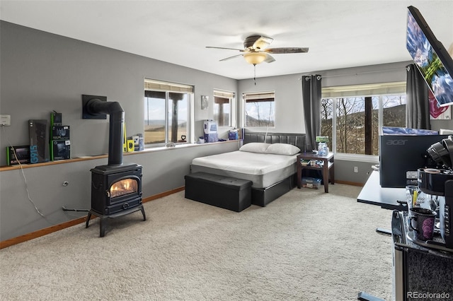 612 Sheep Ridge Rd, Fairplay, CO 80440 - carpeted bedroom with a wood stove and ceiling fan