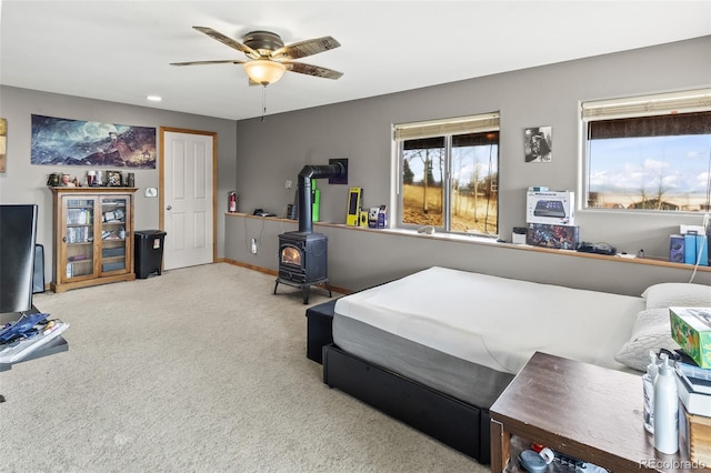 612 Sheep Ridge Rd, Fairplay, CO 80440 - carpeted bedroom with a wood stove and ceiling fan