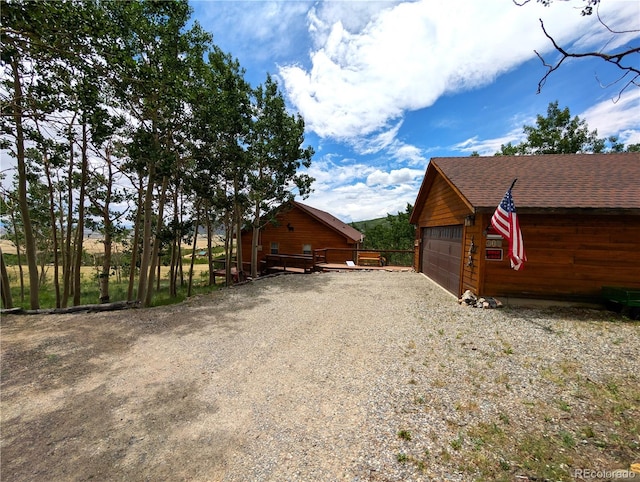 612 Sheep Ridge Rd, Fairplay, CO 80440 - view of home's exterior featuring a shingled roof, an outdoor structure, and a detached garage