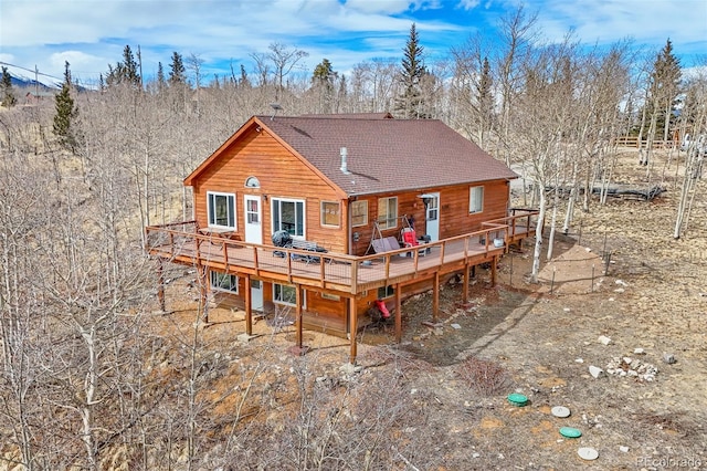 612 Sheep Ridge Rd, Fairplay, CO 80440 - rear view of property with a wooden deck, roof with shingles, and view of wooded area