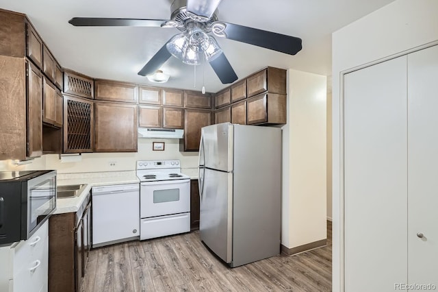 kitchen featuring light wood-type flooring, dark brown cabinets, white appliances, and ceiling fan