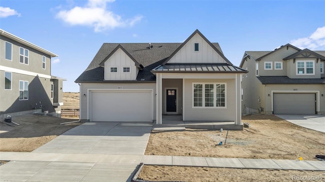 view of front of home featuring metal roof, a garage, concrete driveway, board and batten siding, and a standing seam roof