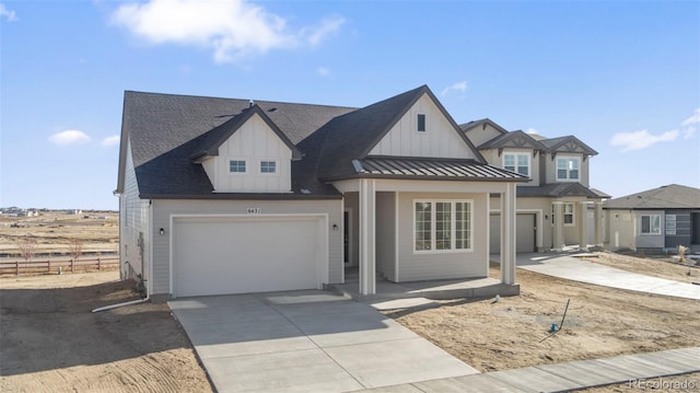 view of front of home with a standing seam roof, fence, metal roof, a garage, and driveway