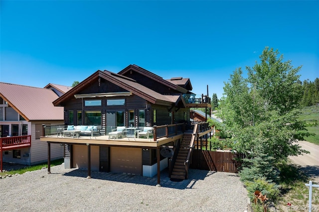 151 County Road 644, Grand Lake, CO 80447 - view of front of home featuring a wooden deck, an attached garage, gravel driveway, and stairway