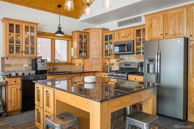 151 County Road 644, Grand Lake, CO 80447 - kitchen with stainless steel appliances, a kitchen breakfast bar, tasteful backsplash, and hanging light fixtures