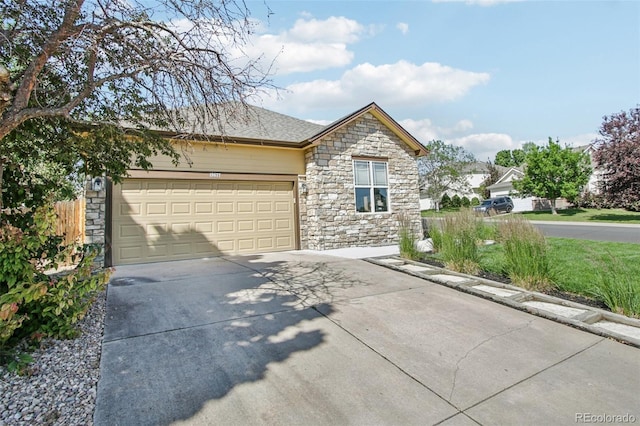 19677 E Vassar Dr, Aurora, CO 80013 - view of front of home featuring stone siding, concrete driveway, and an attached garage